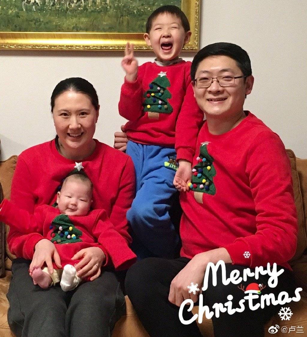 大儿子站在爸爸怀里,比着剪刀手笑得很是开心,卢兰与老公也都