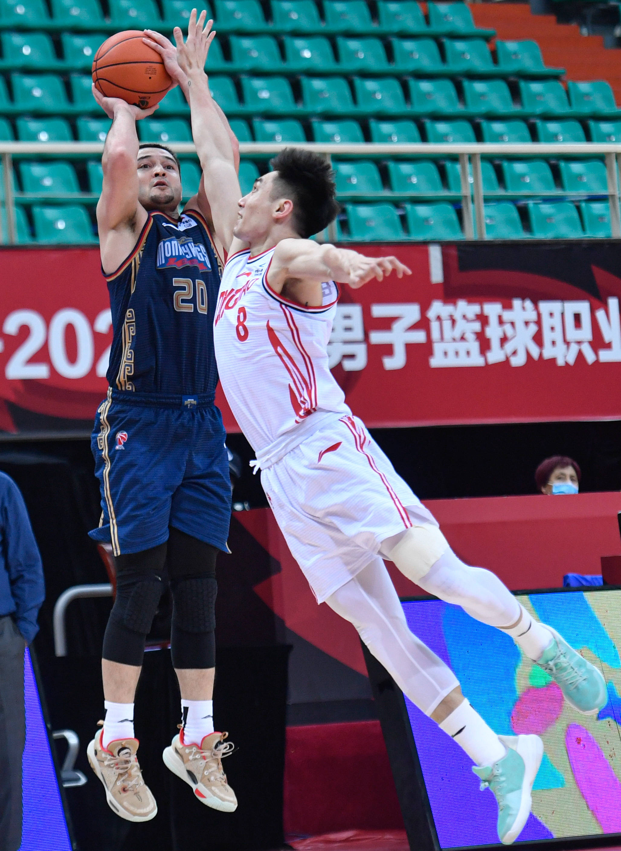 3月30日,南京同曦宙光队球员西热力江(左)在比赛中投篮.