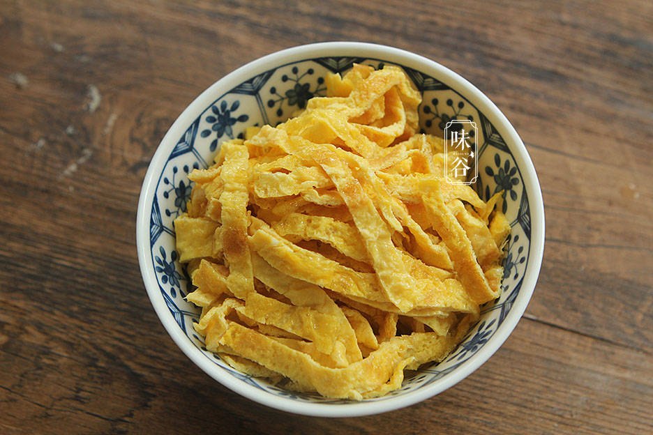 3,蛋皮晾凉后先对半切开,再叠在一起切成蛋丝备用