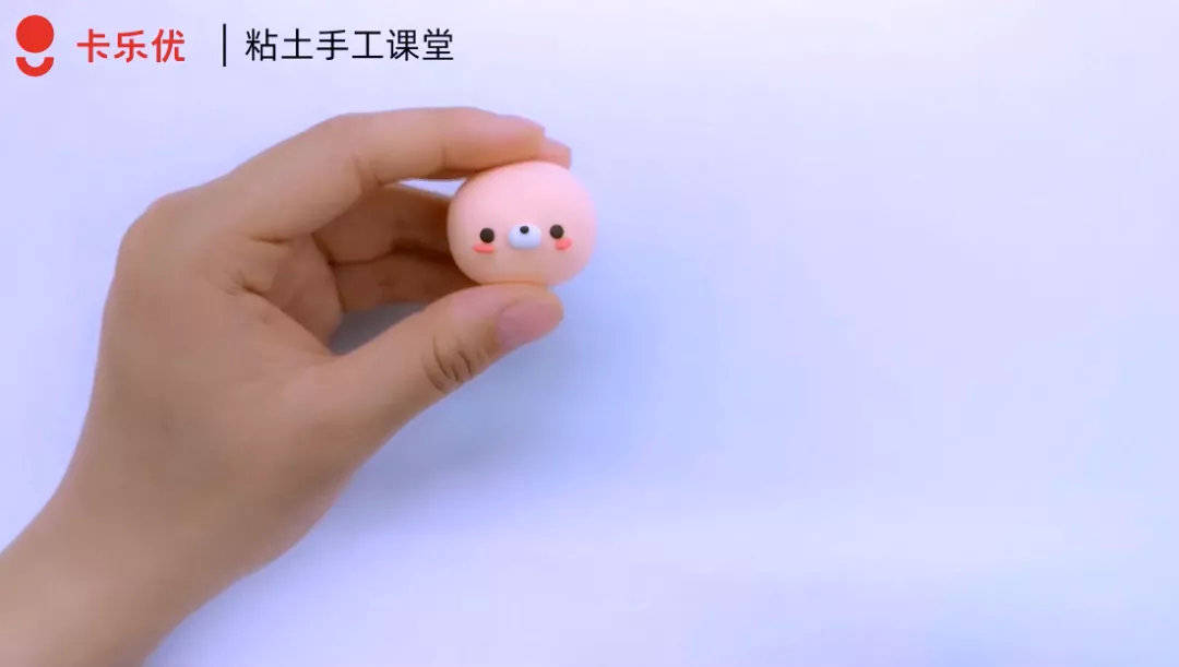 步骤①:用肤色粘土捏一个小圆脑袋,再加上可爱的五官,然后借助剪刀和