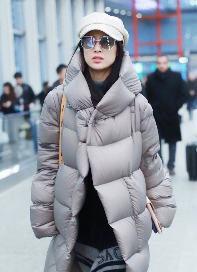 黄圣依穿着的羽绒服为宽松的版型,看上去有点厚重,不过跟她露出来的