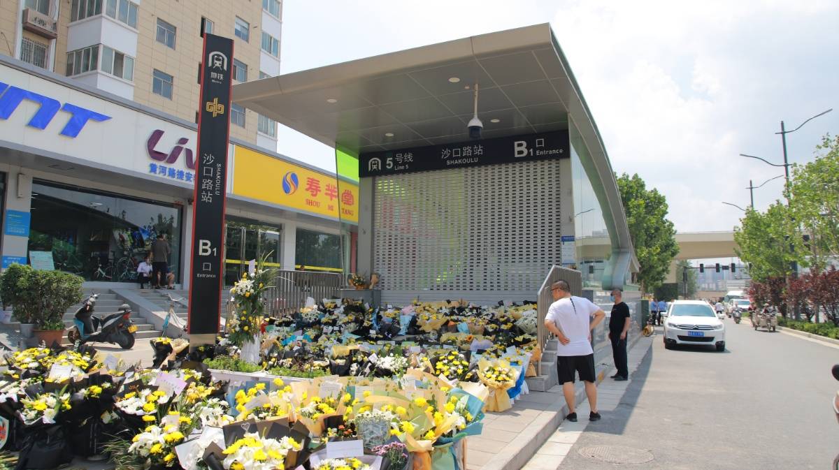 郑州地铁口围挡被拆除 入口摆满鲜花卡片祭奠逝者