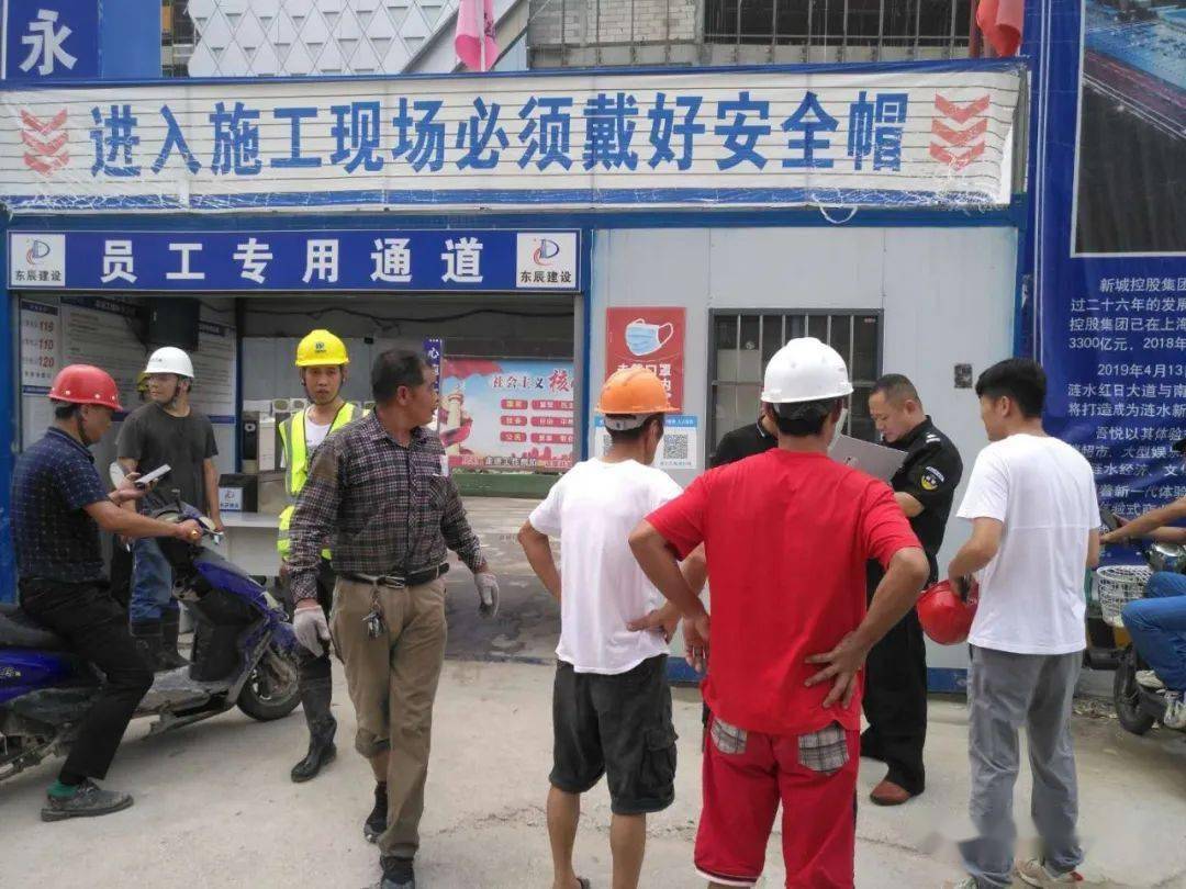 十多名头戴安全帽的工人围坐在工地项目部门前,一霎时工地进出受阻