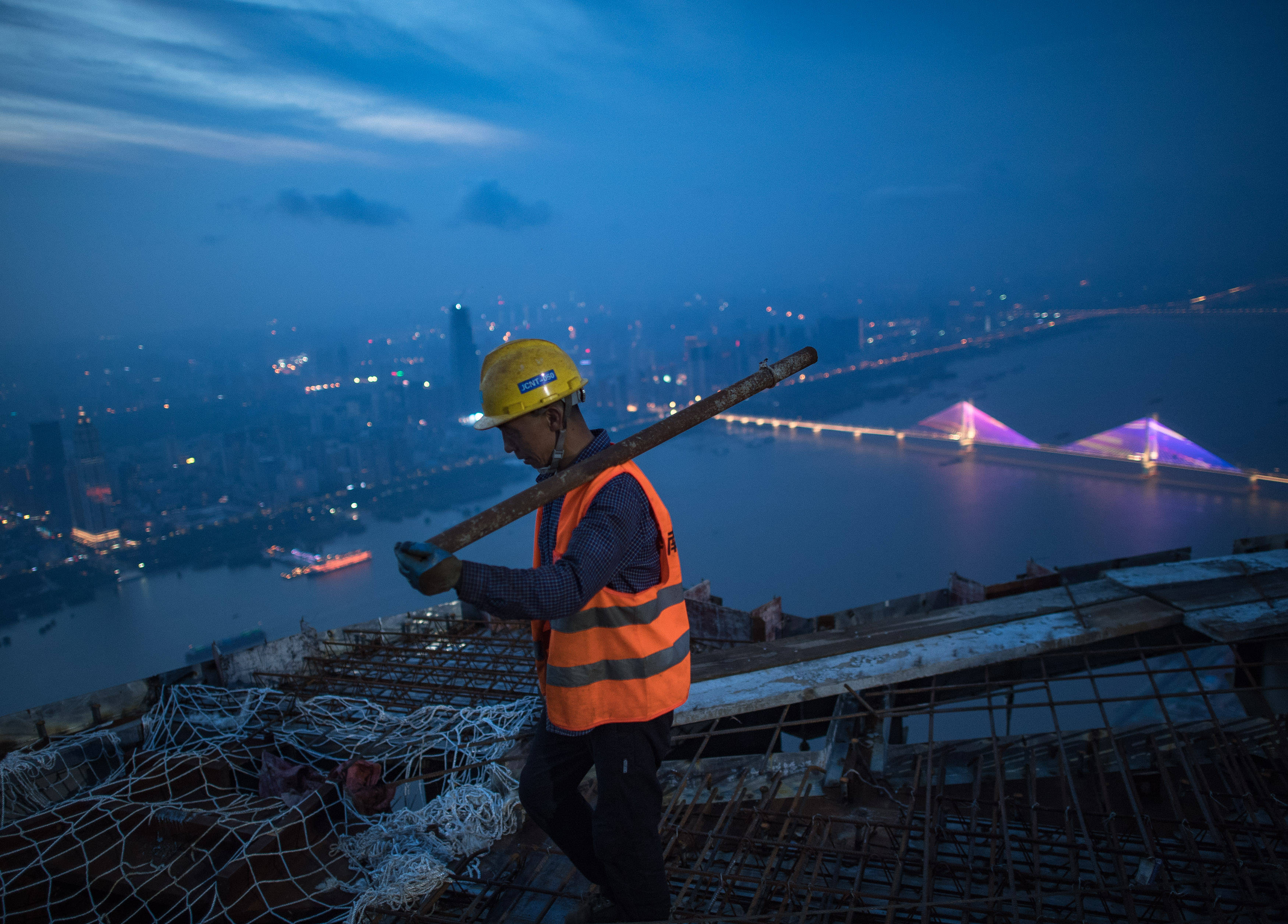 8月11日傍晚,工人在武汉绿地中心项目建设现场近500米的高空施工.