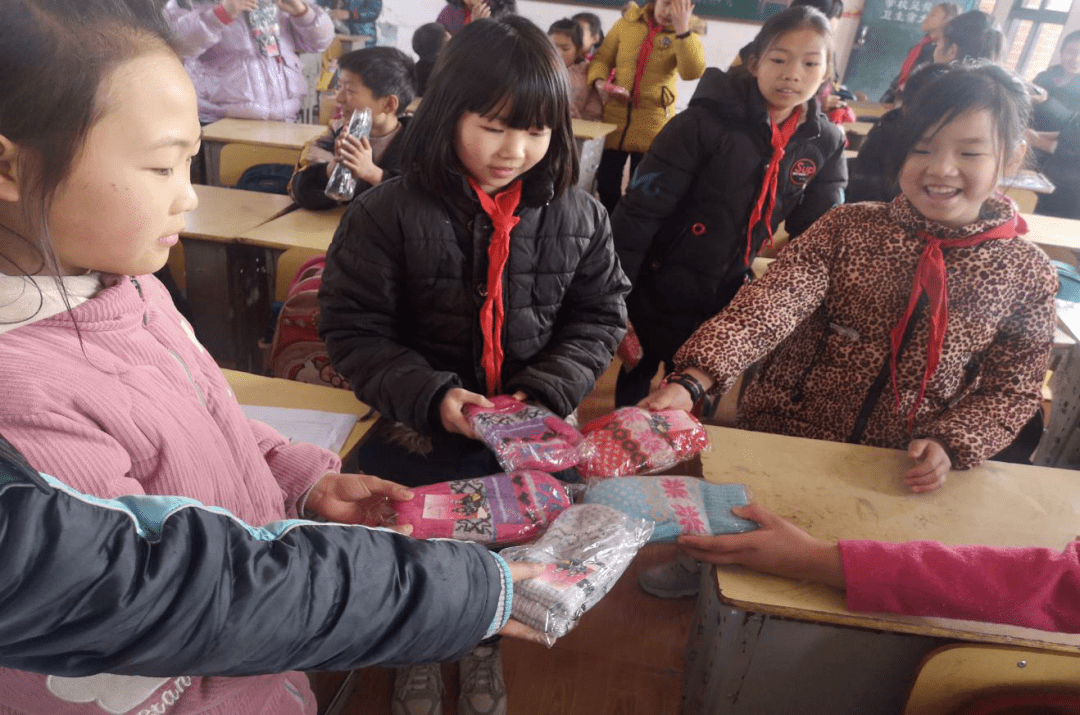 (学校老师为学生发放手套)因遵守我市防控措施,积极做好防护措施,减少