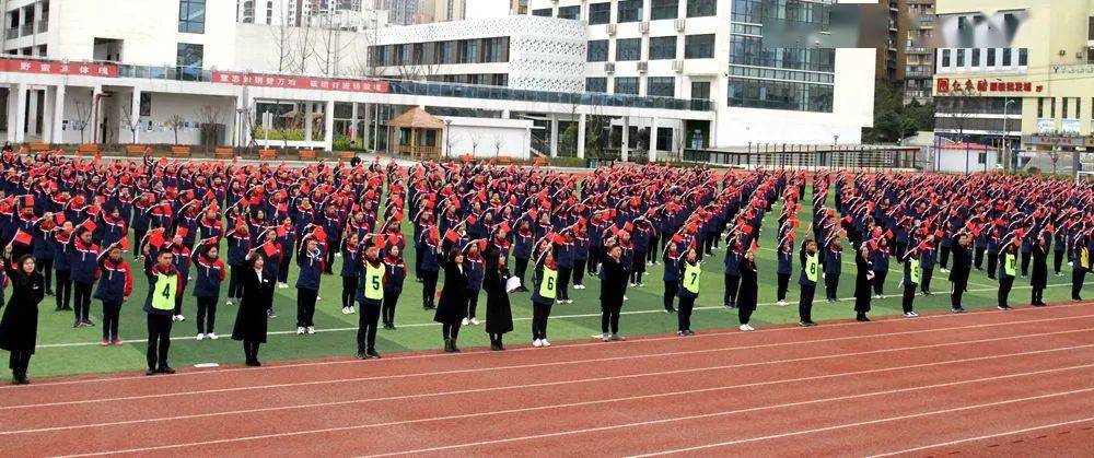 共抒爱国情"开学典礼师生们严肃认真,手举红旗在向阳桥中学的操场上