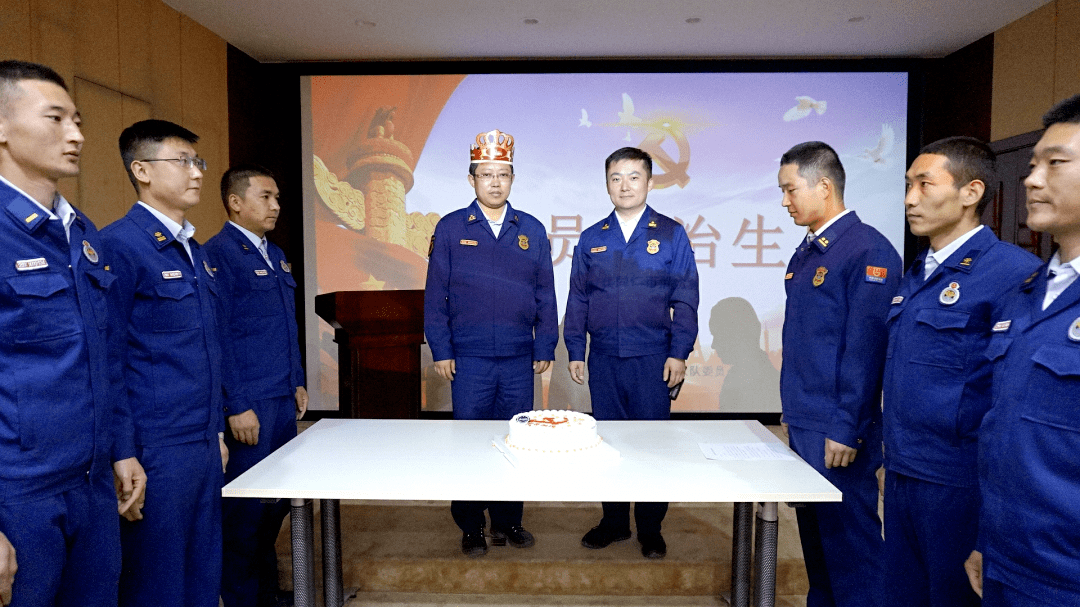 政治生日蛋糕"活动中,支队长吴彬代表支队党委为机关党员代表佩戴党徽