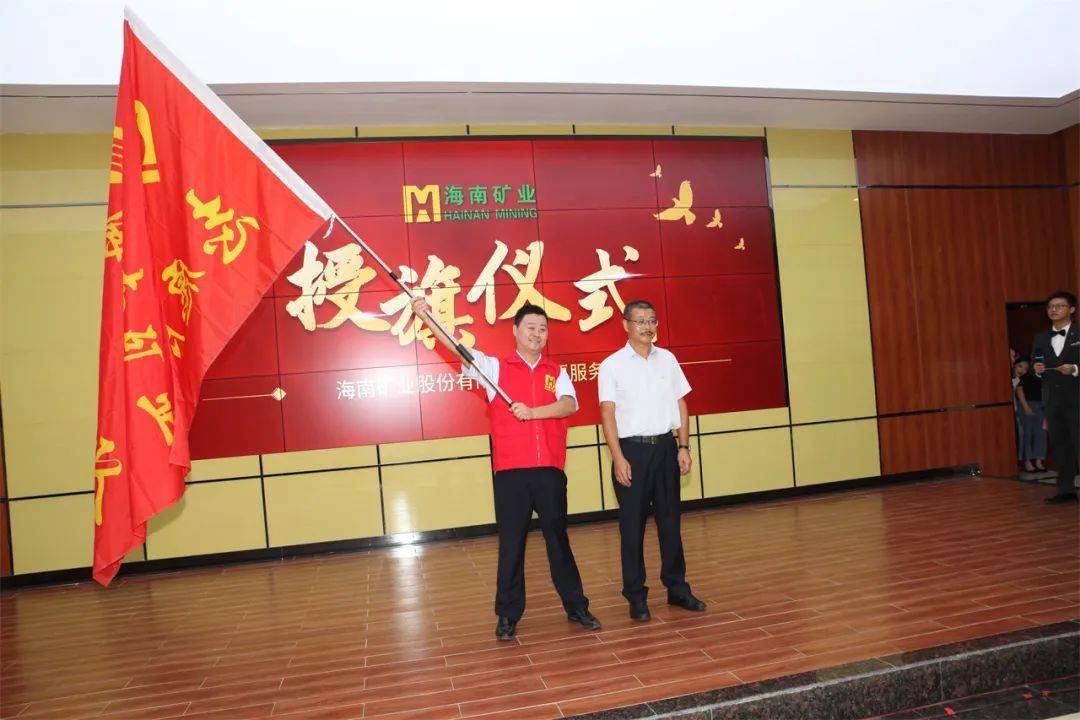 刘明东为海南矿业志愿服务队授旗,郭风芳,许达全,吴旭春分别为三个